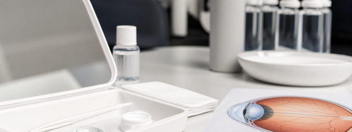 Scleral lens care supplies and an eye diagram on a clean clinical exam desk