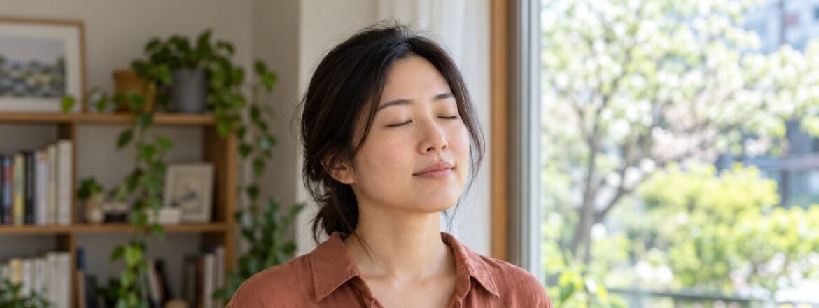 Woman in a terracotta shirt resting with eyes closed beside a bright home window